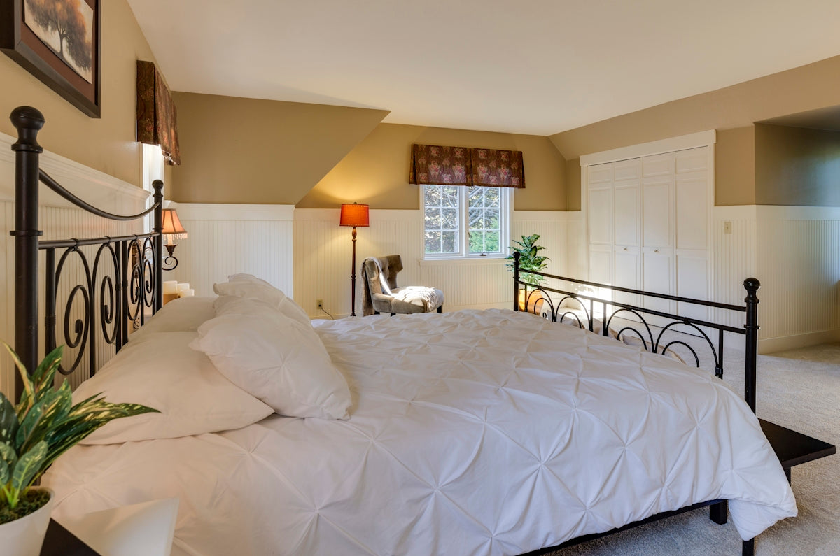 white mattress sheet and four white pillows