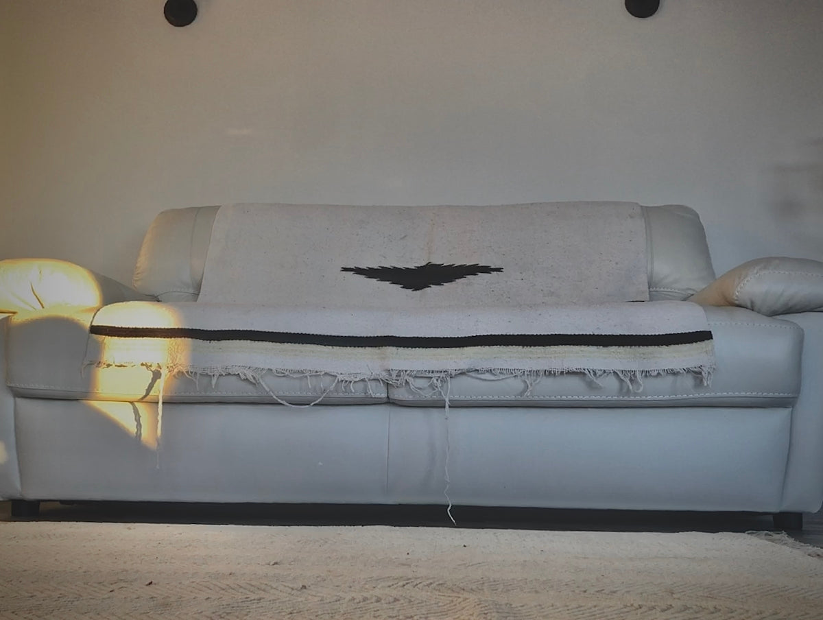 a white couch with a bat on it