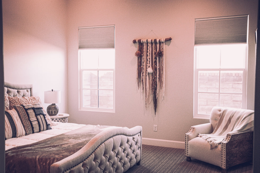 white bed near window with brown curtain