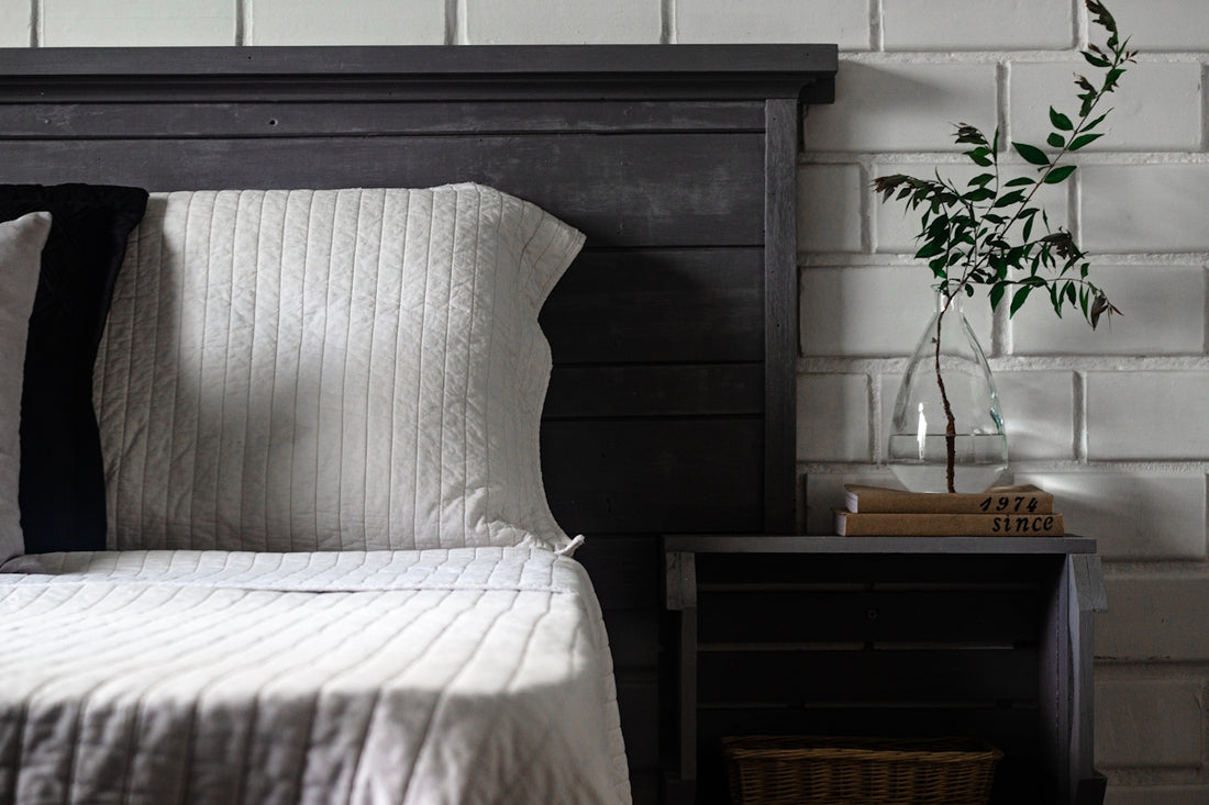 a bed with a vase of flowers