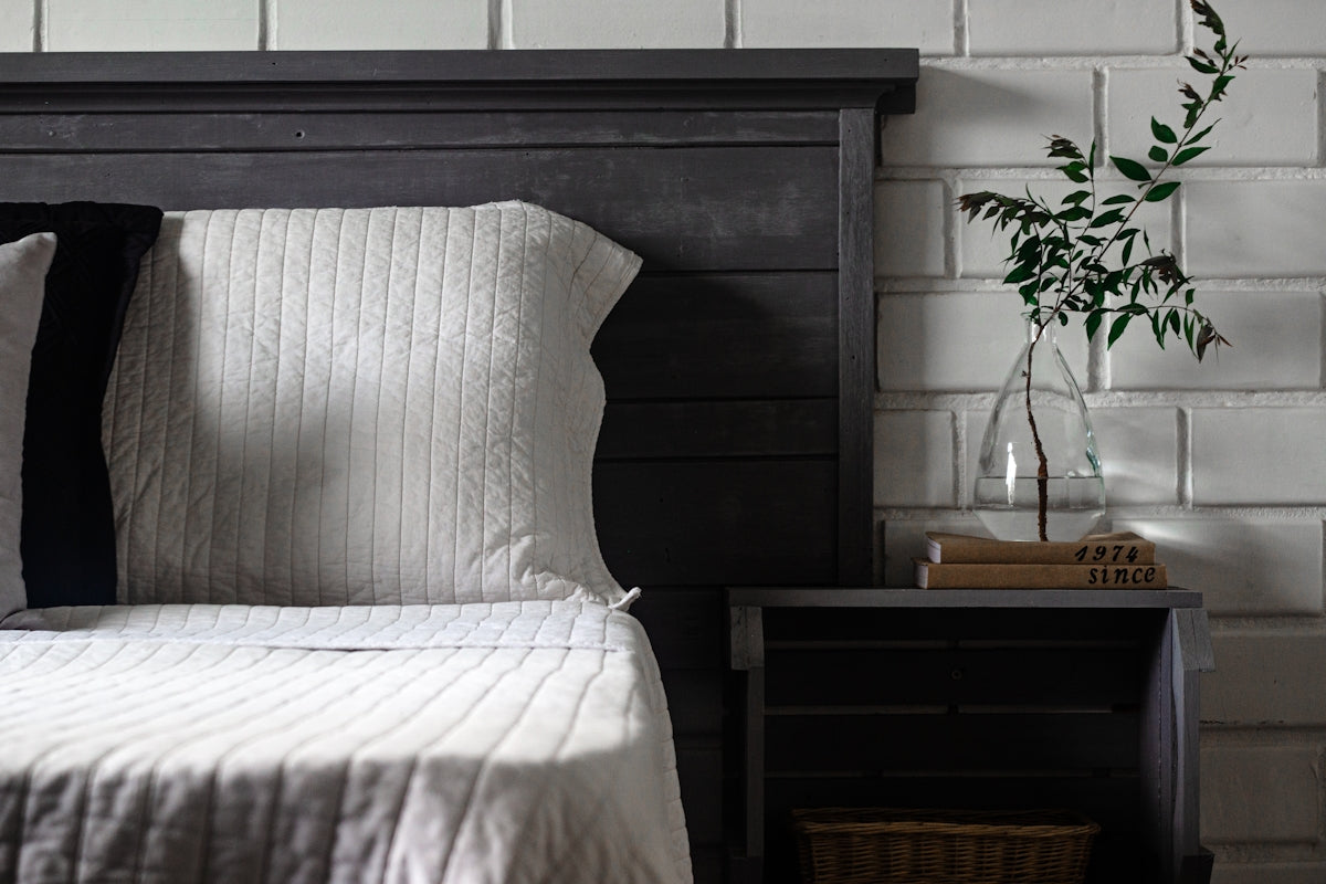 a bed with a vase of flowers