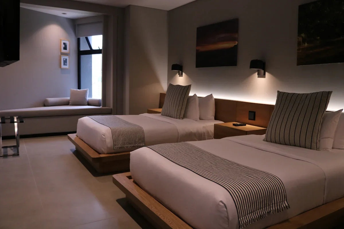 a hotel room with two beds and a couch