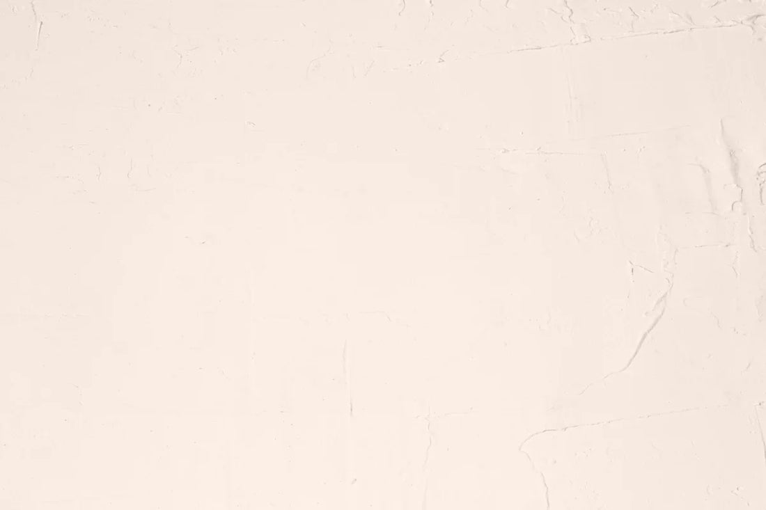 A white sheet with a black cat sitting on top of it