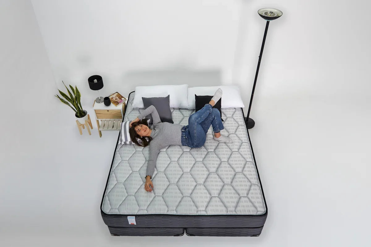 Woman relaxing on a mattress with headphones on.