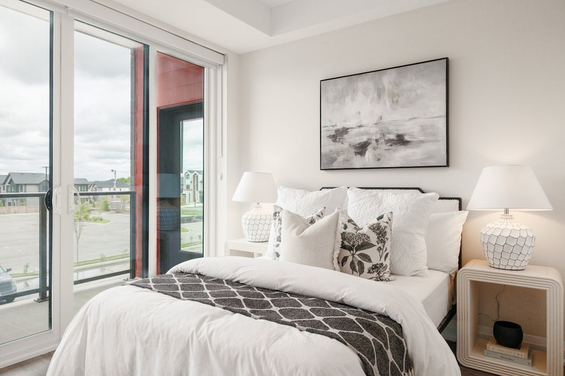 Modern bedroom with a large window and artwork.