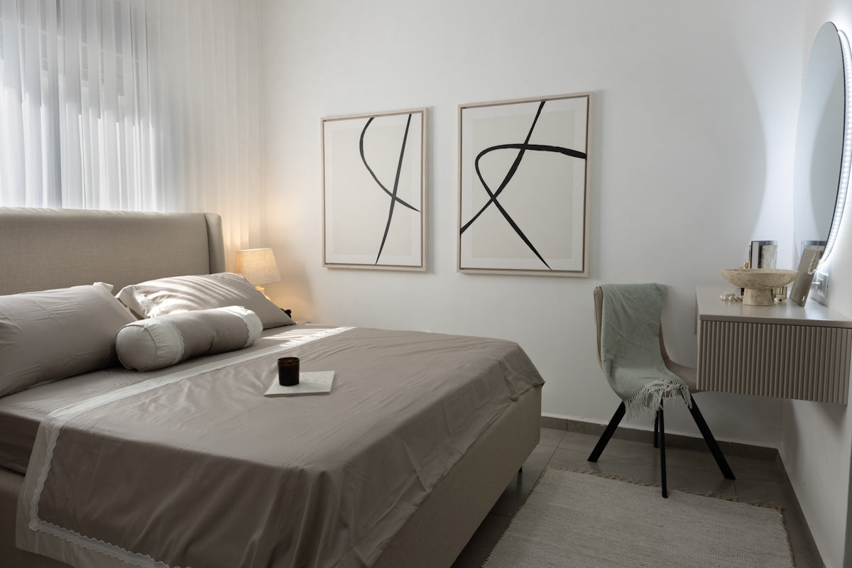A modern bedroom with a bed and vanity table.