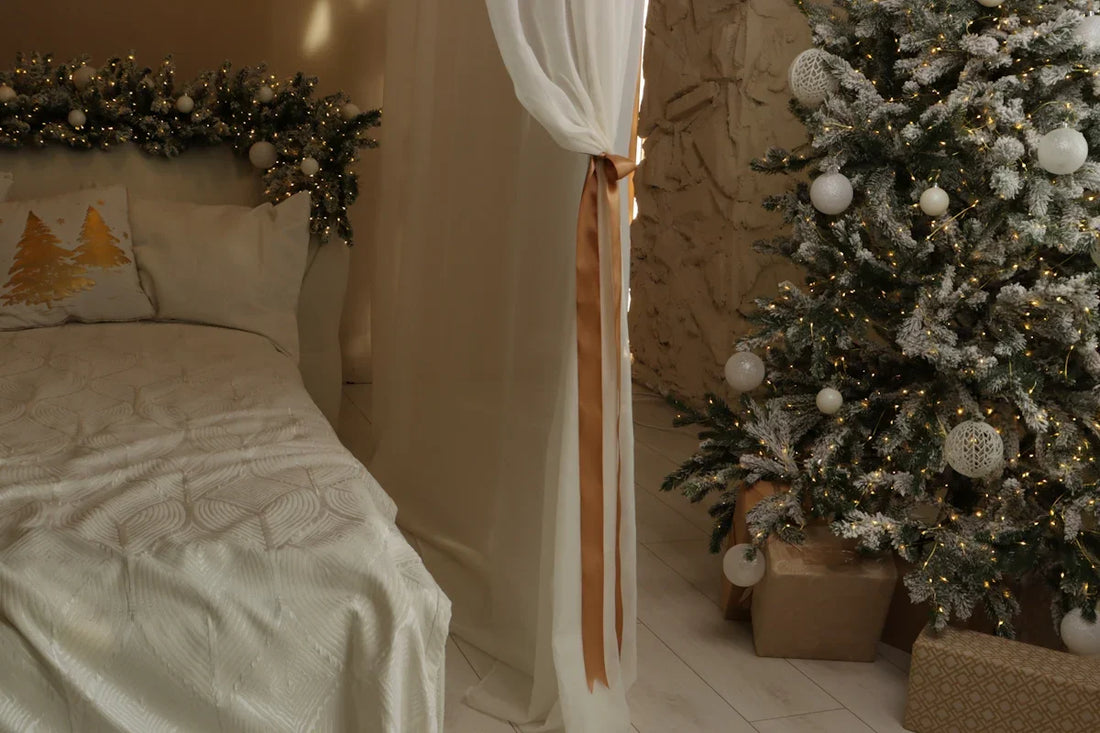 Cozy bedroom decorated for christmas with a tree.