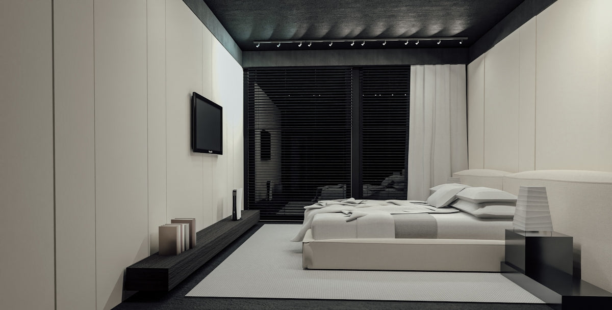 Modern bedroom with a large bed and television.