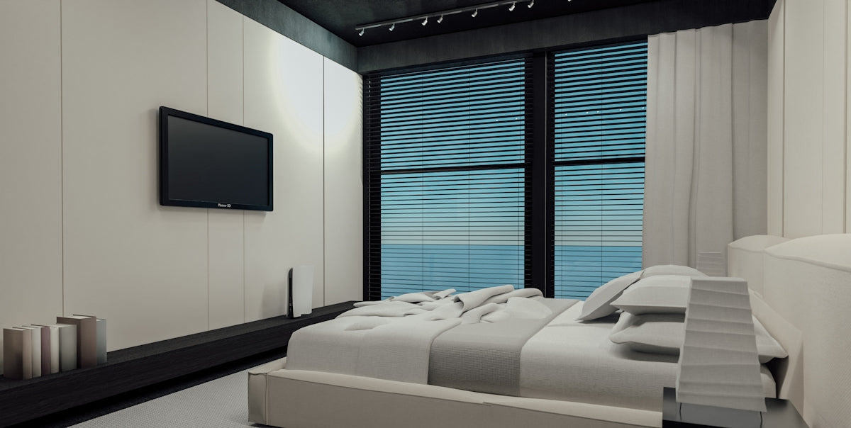 Modern bedroom with ocean view and mounted television.