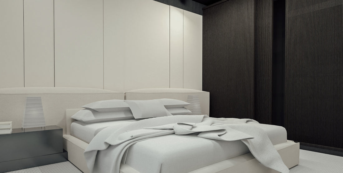 Modern bedroom with white bedding and dark wall.