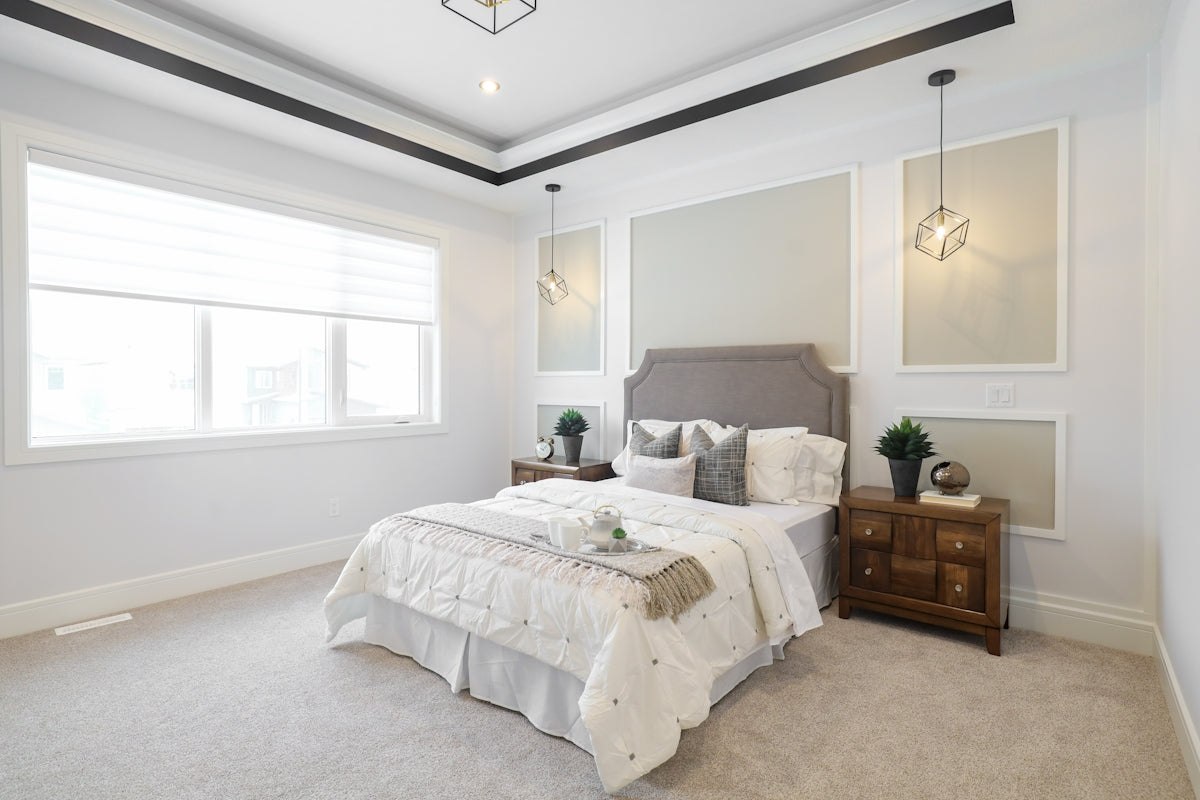 A well-decorated bedroom with a large window.