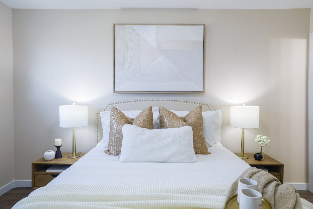 A neatly made bed with decorative pillows and bedside lamps.