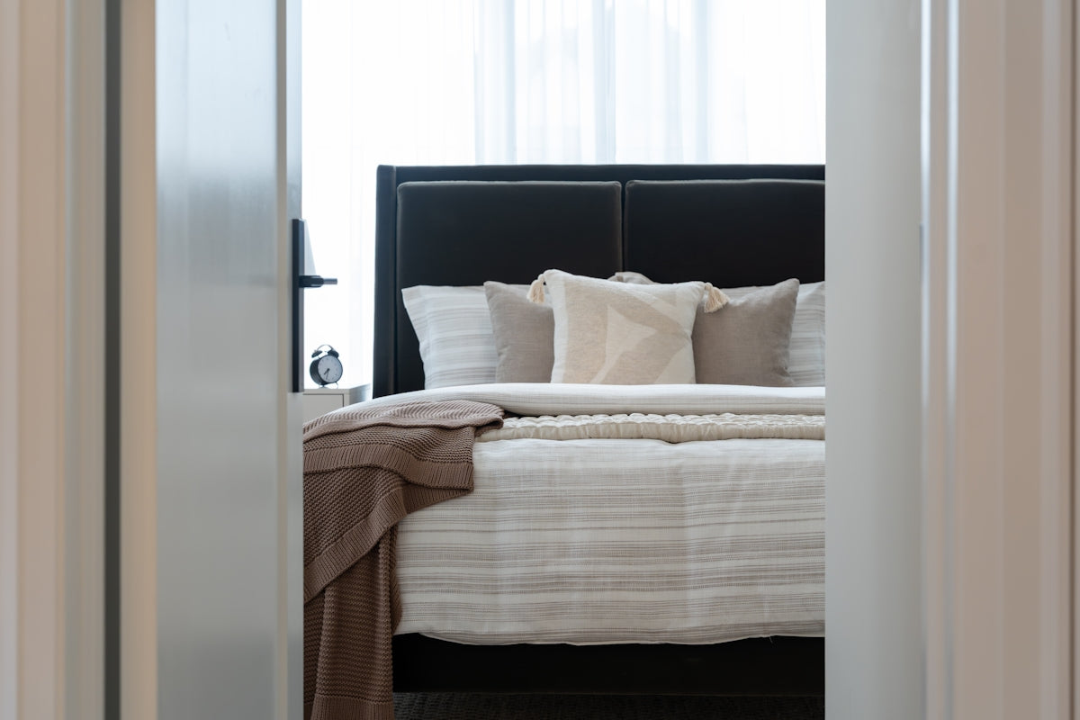 View of a neatly made bed with pillows and pillows.