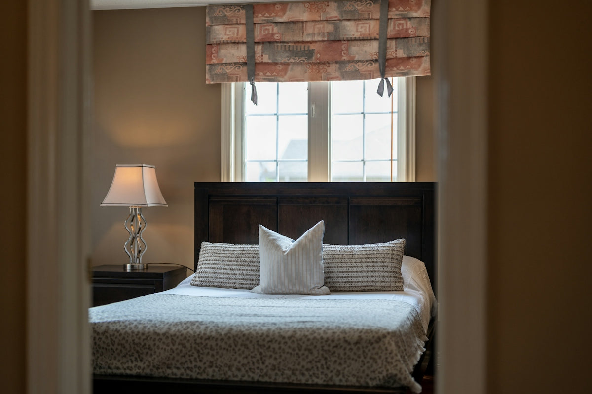 A cozy bedroom with a queen-size bed and window