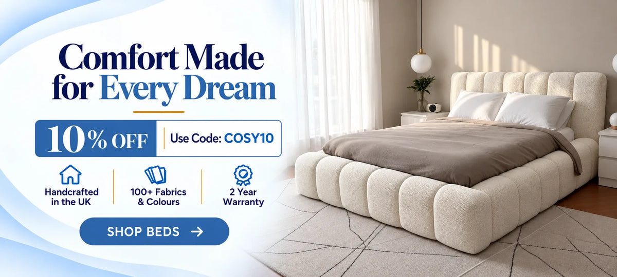 A tufted cream upholstered platform bed with a matching headboard in a bright bedroom, alongside promotional text offering 10% off with code COSY10 and features like handcrafted in the UK and 2 year warranty.
